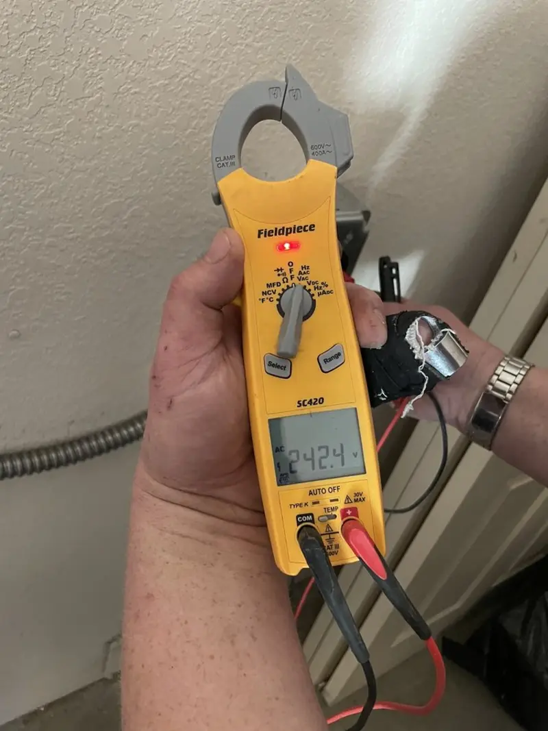 Voltage testing with clamp meter during Outlet Installation in Vienna